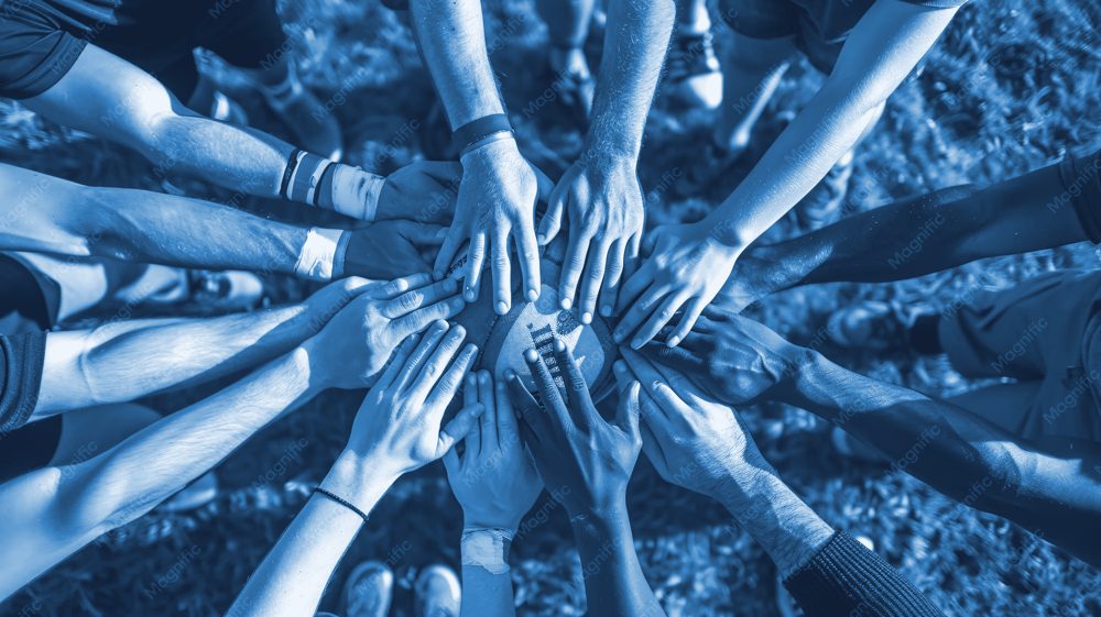 A team stacking hands together in a huddle