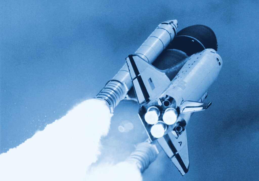 Space shuttle climbing through the clouds after launch, solid rocket boosters trailing white exhaust